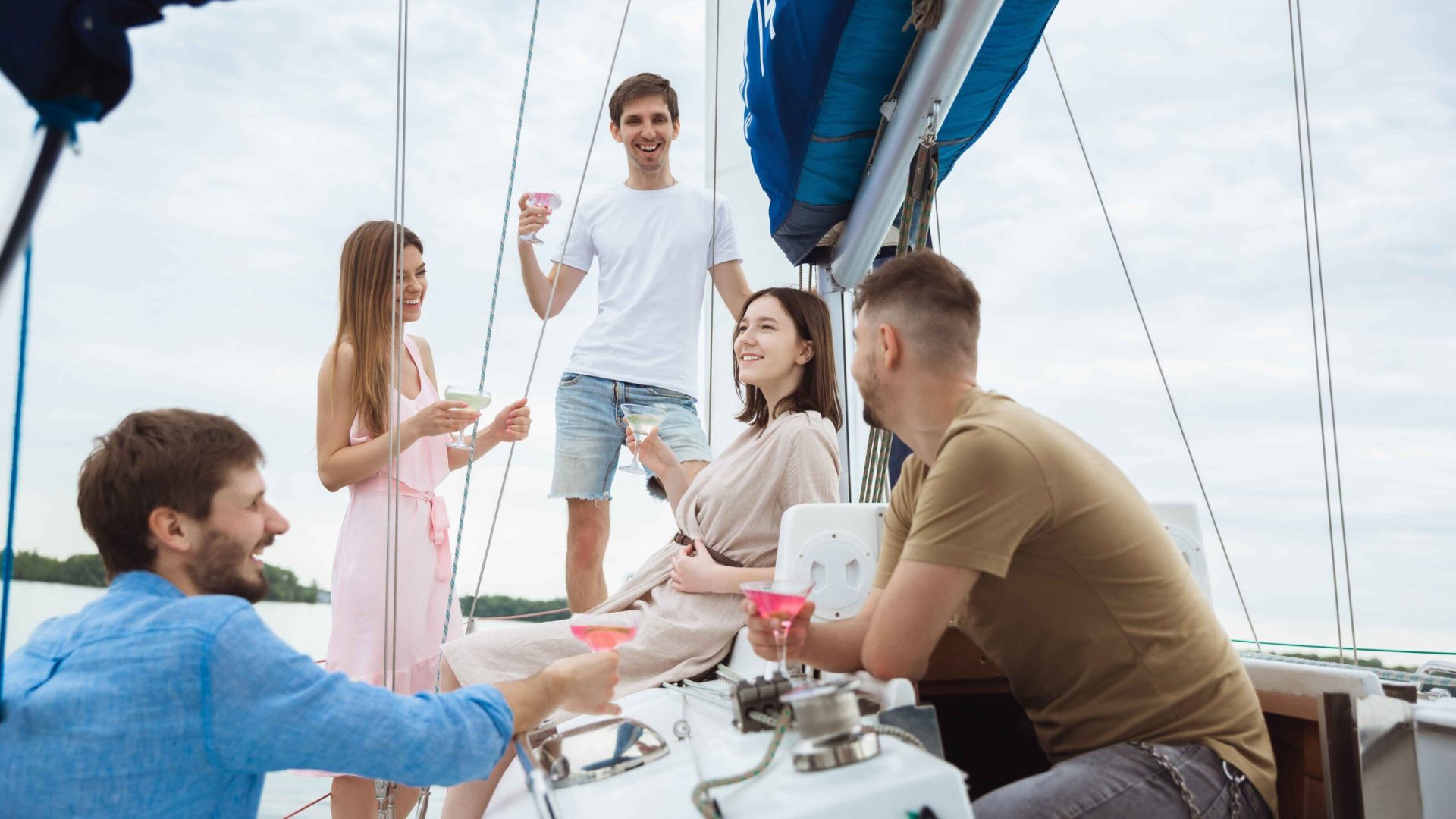 group-happy-friends-drinking-vodka-cocktails-boat